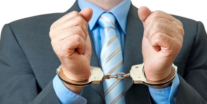 Businessman in handcuffs